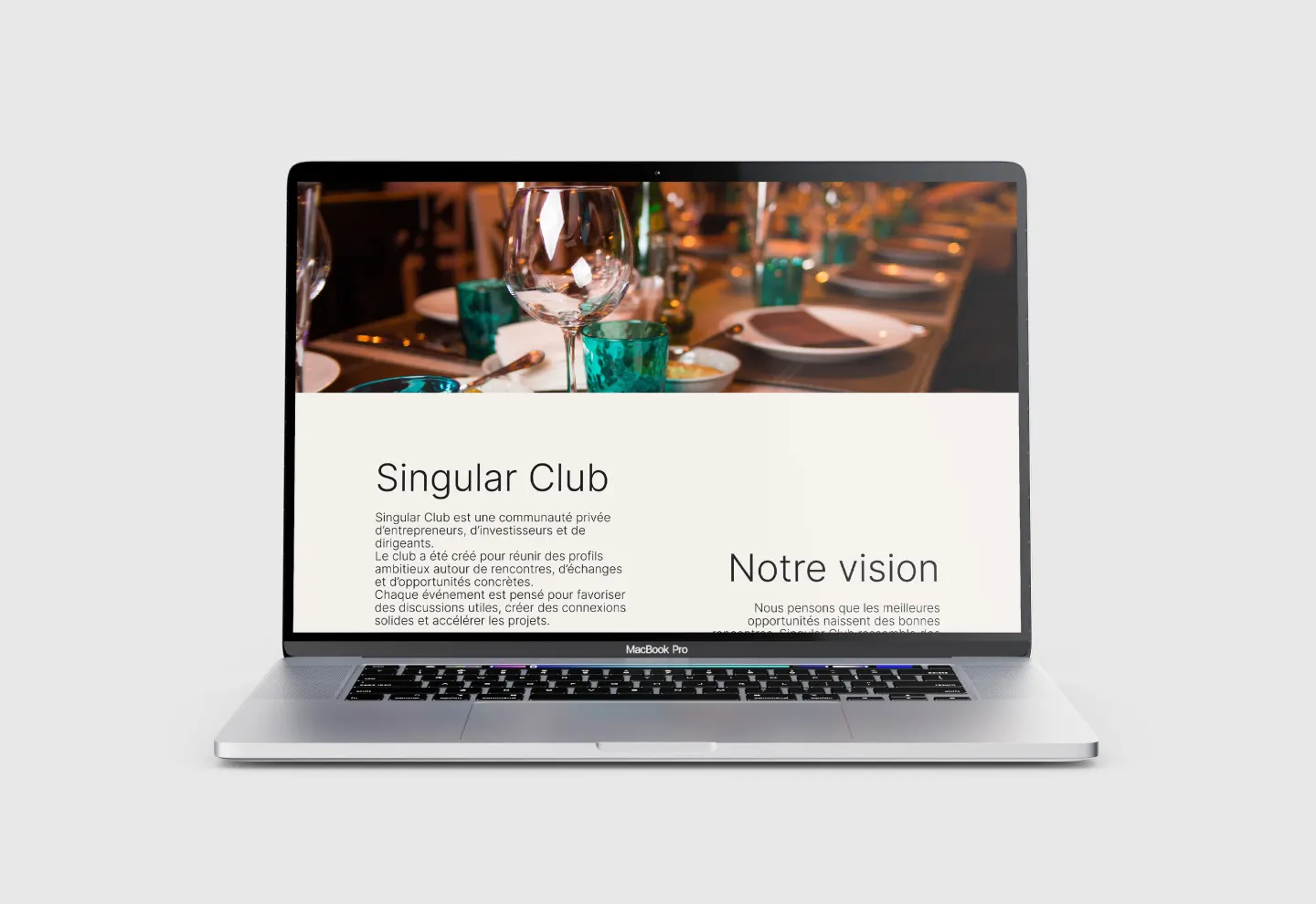 Singular Club website homepage shown on a MacBook Pro